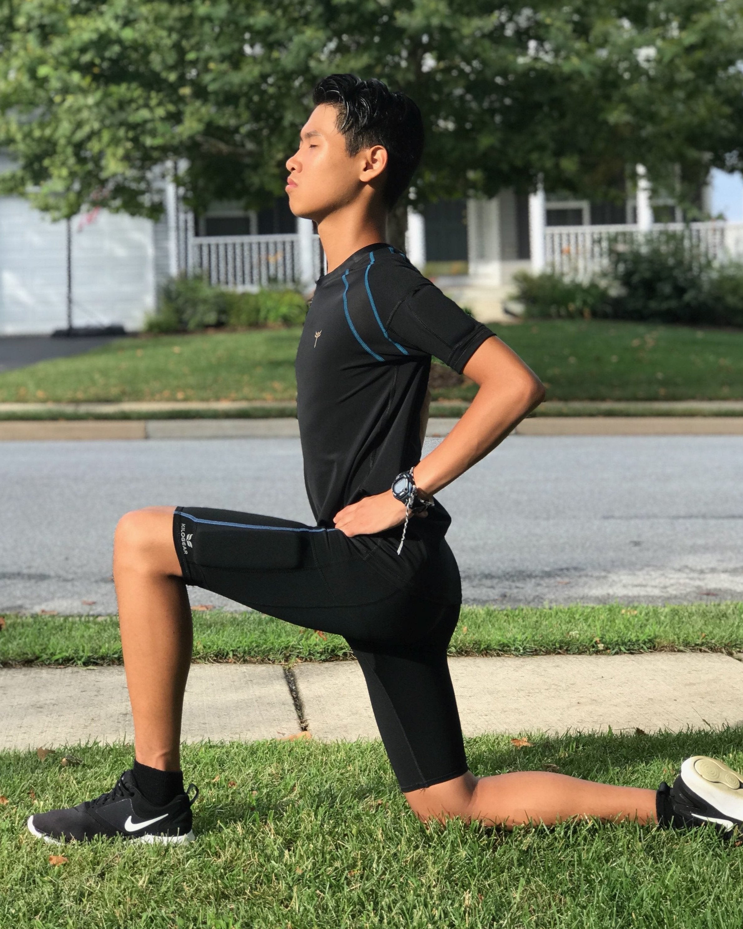 Black short sleeve training top for boys with integrated bicep weights, designed for muscle engagement and strength enhancement.