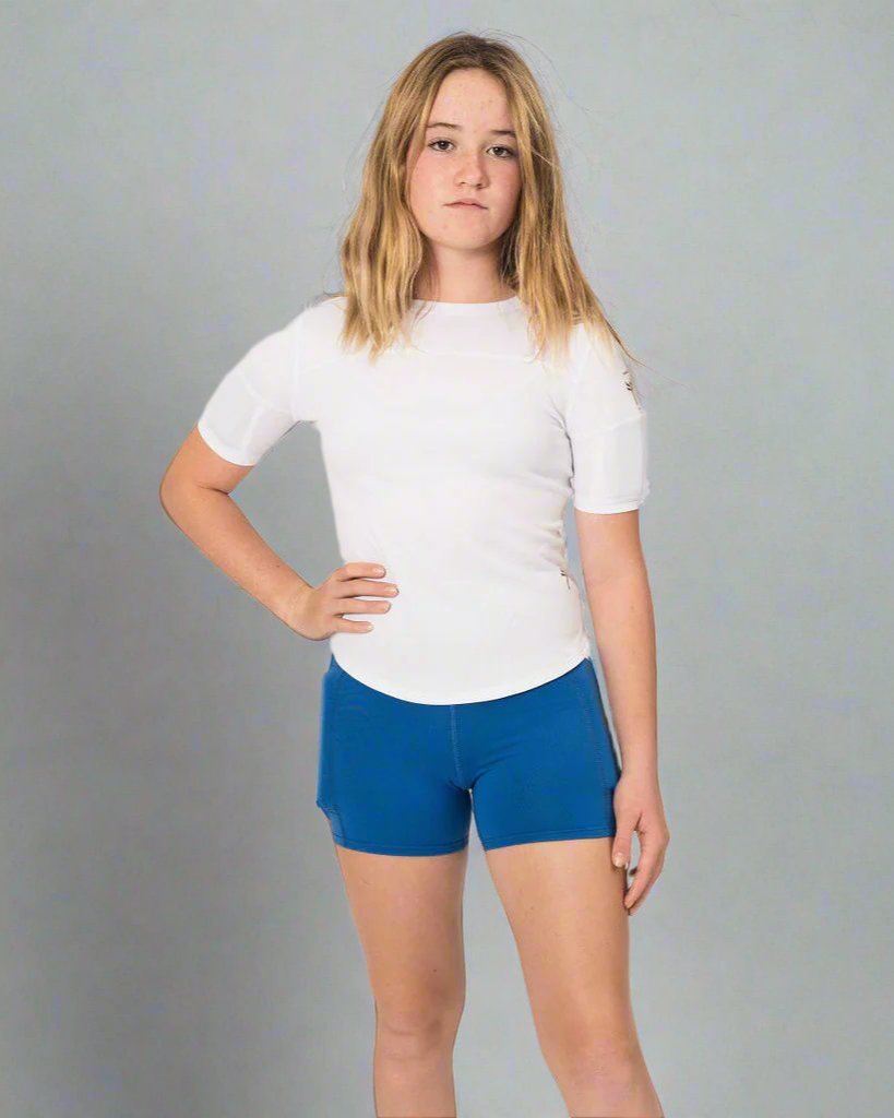 Girl wearing weighted white short sleeve and teal weighted shorts, front view showing weights on the side of the leg, just under the hips