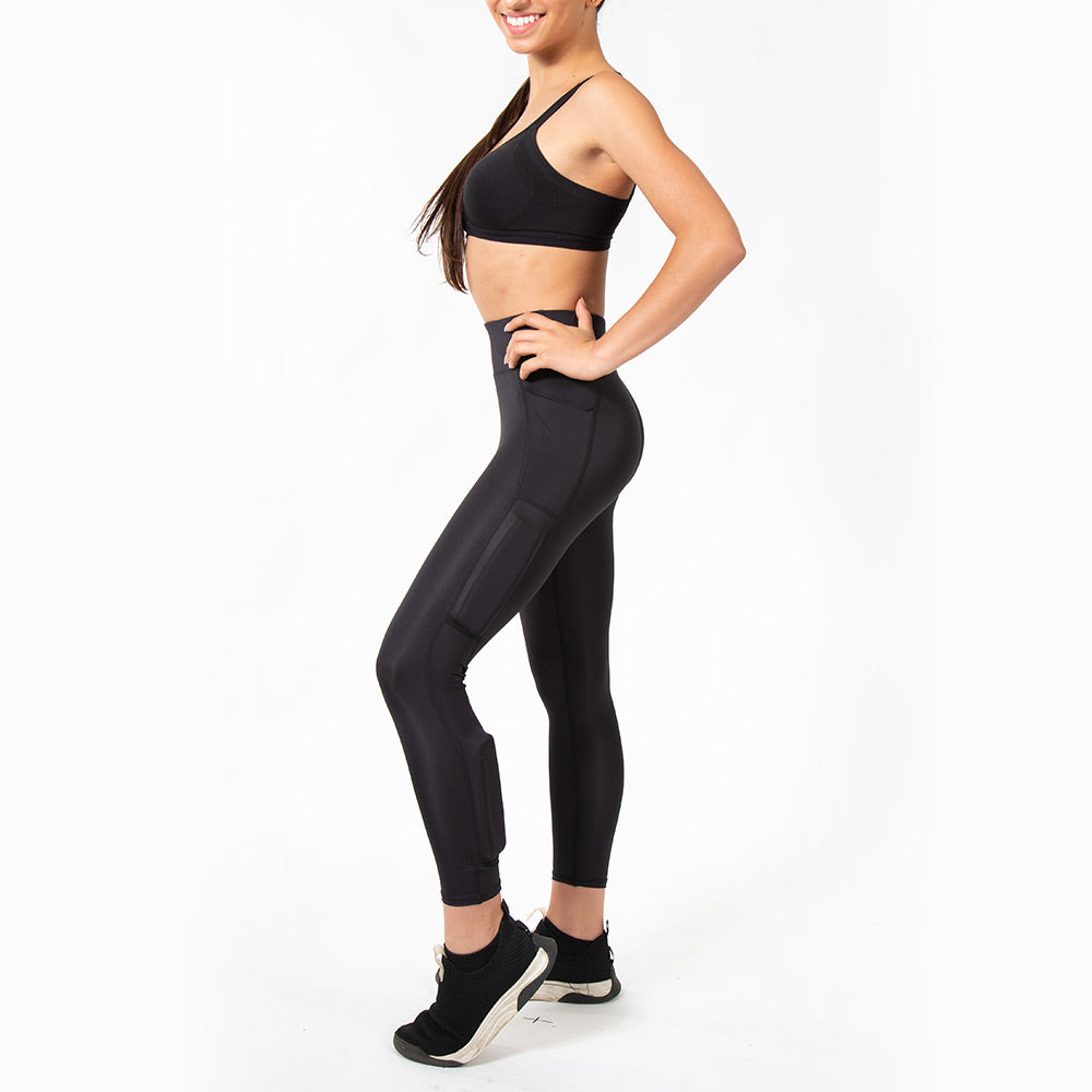 Girl wearing black kilogear cut legging showing weights on the calf and quad, side view