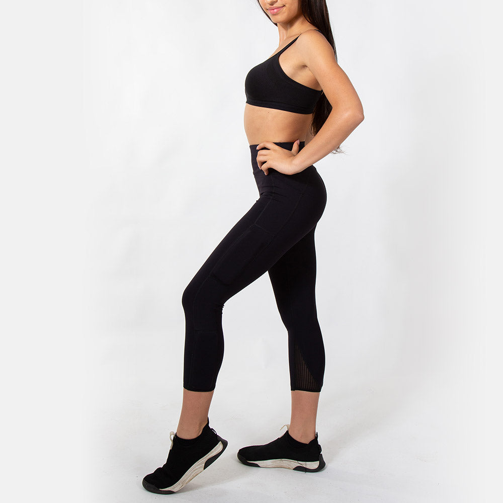 Side view of girl wearing black legging with weight above the knee on the side and below the knee, on the side calf