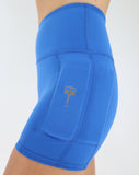 side view of teal weighted shorts with the weights on the side of the leg, below the hips