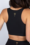 Rear facing image of the royal black bra with razor back and kilogear cut logo in the center back