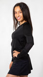 Side view of woman wearing the long sleeve zip up top, showing arm weights on the left arm.