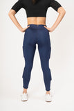 rear view of woman wearing black weighted crop top and shiny navy weighted legging