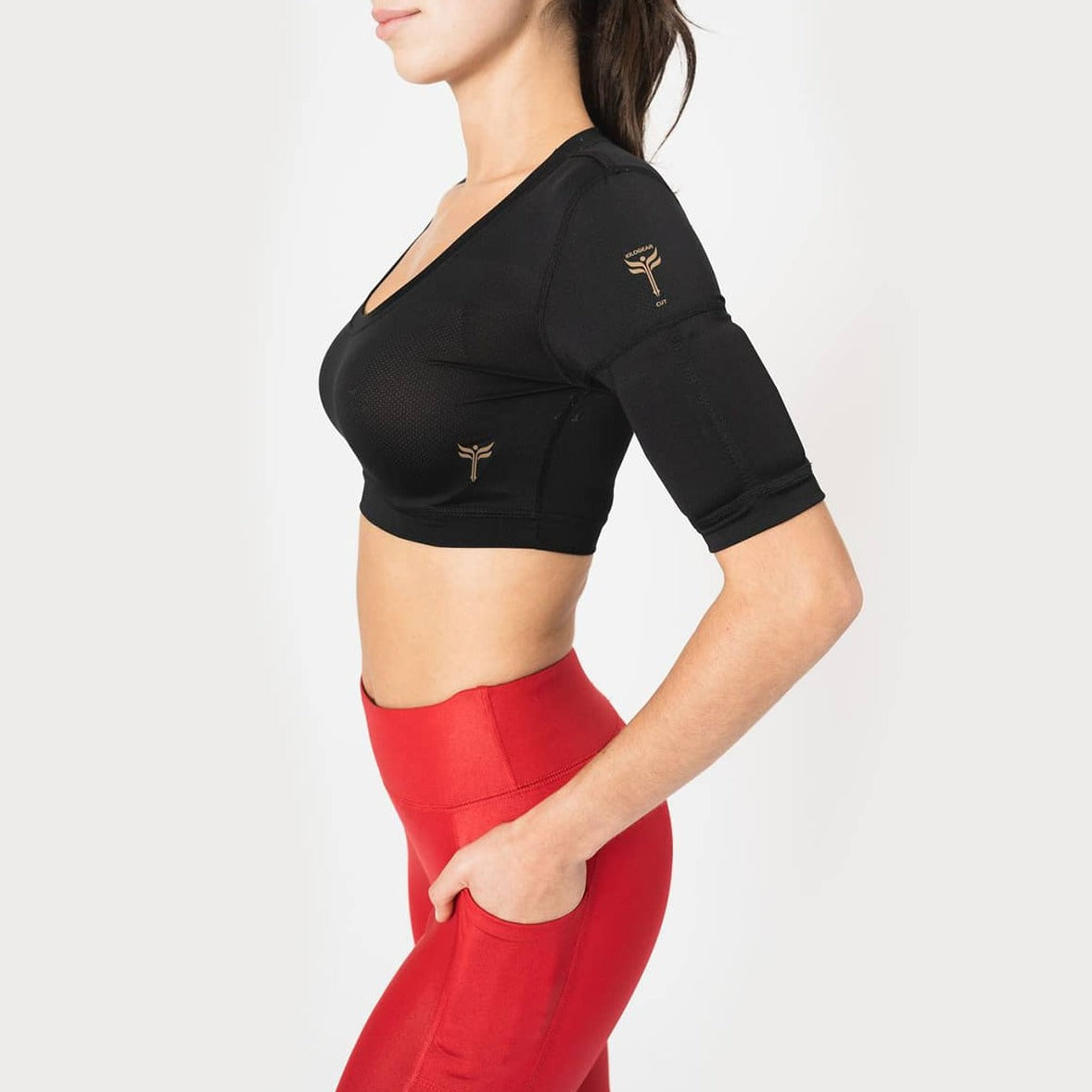 Showing black crop top with scoop neck. Two weight pockets on  the biceps of the arm.